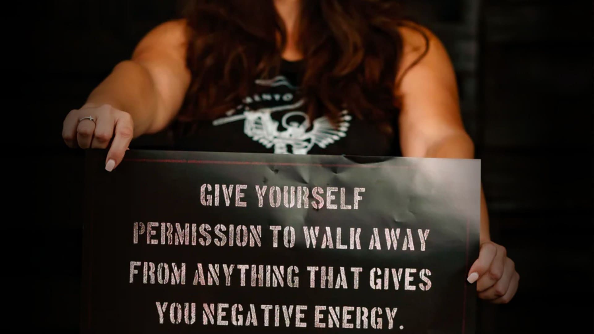 woman holding a Rogue American poster